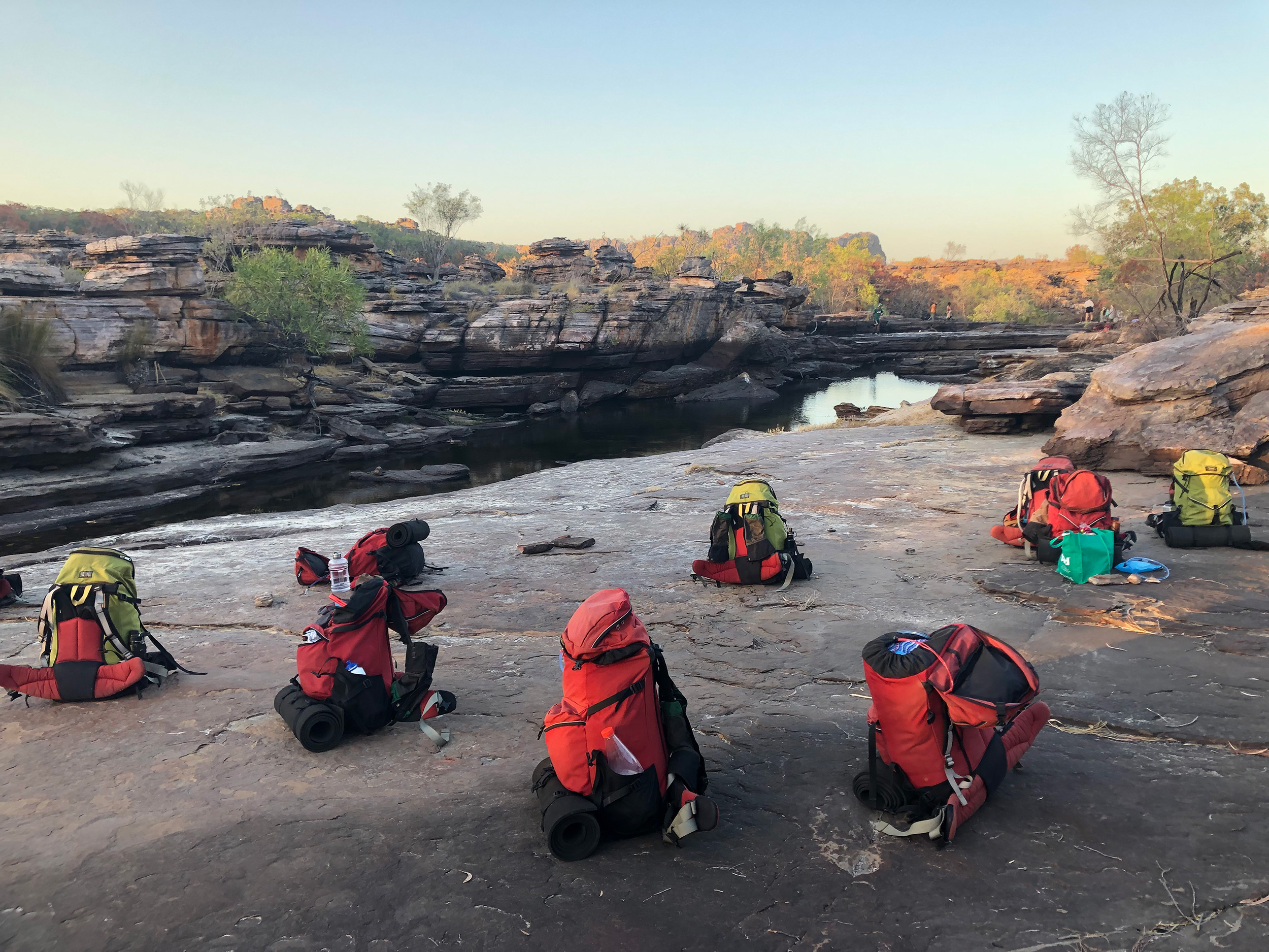 Backpacks on large rocks, Jabiru