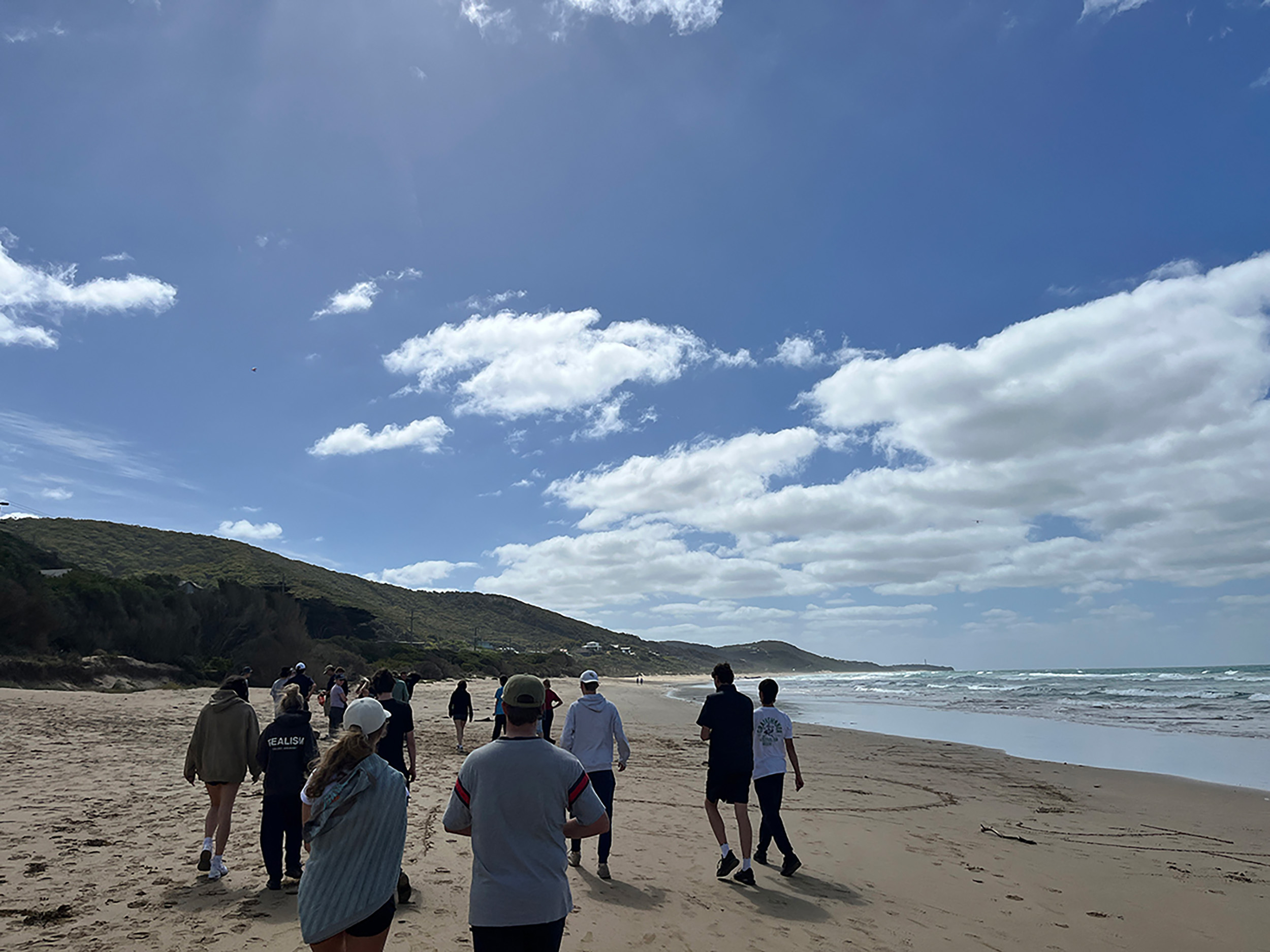 Group of students on excursion at the beach