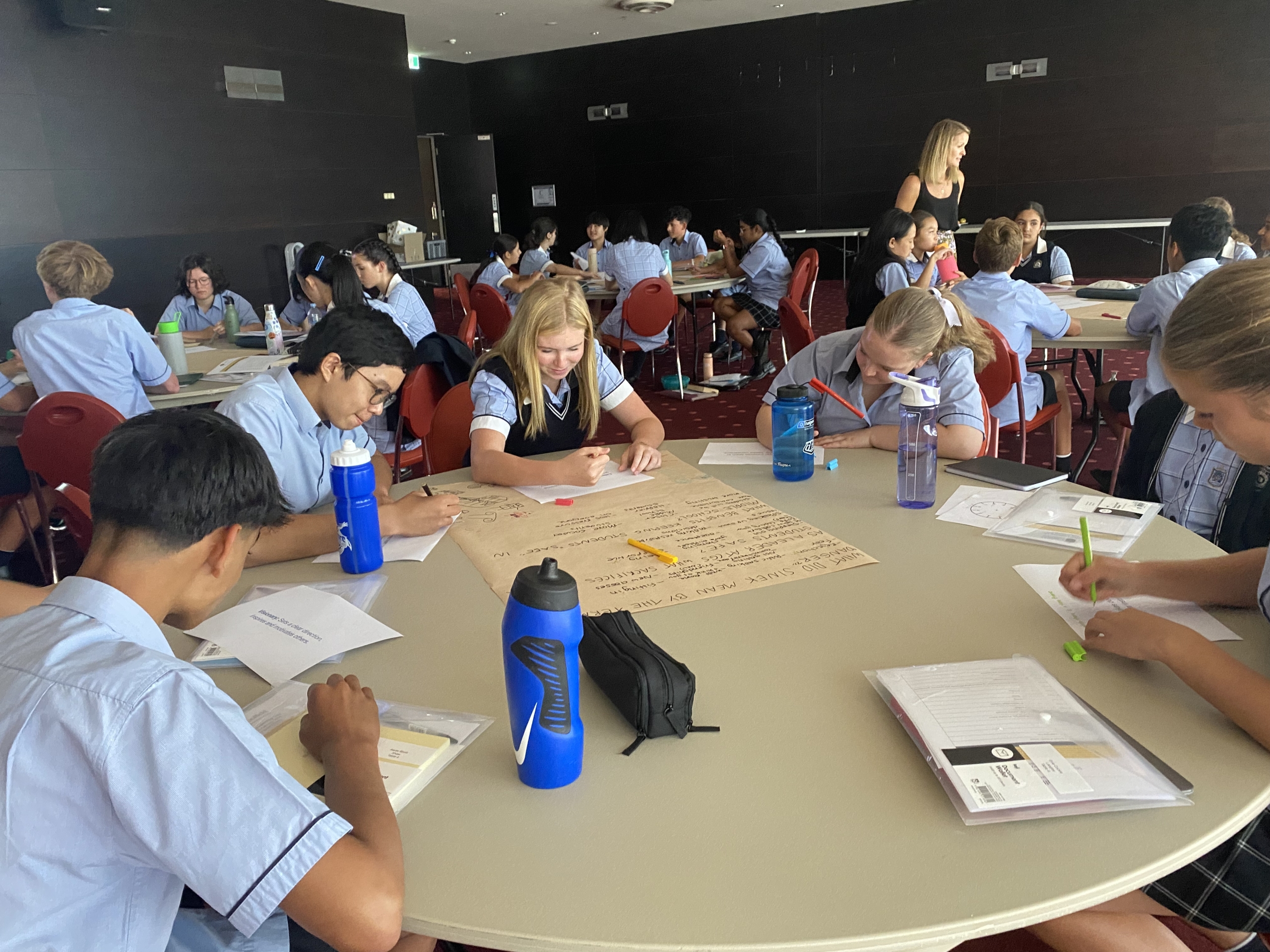 Students sitting around a round table in a classroom